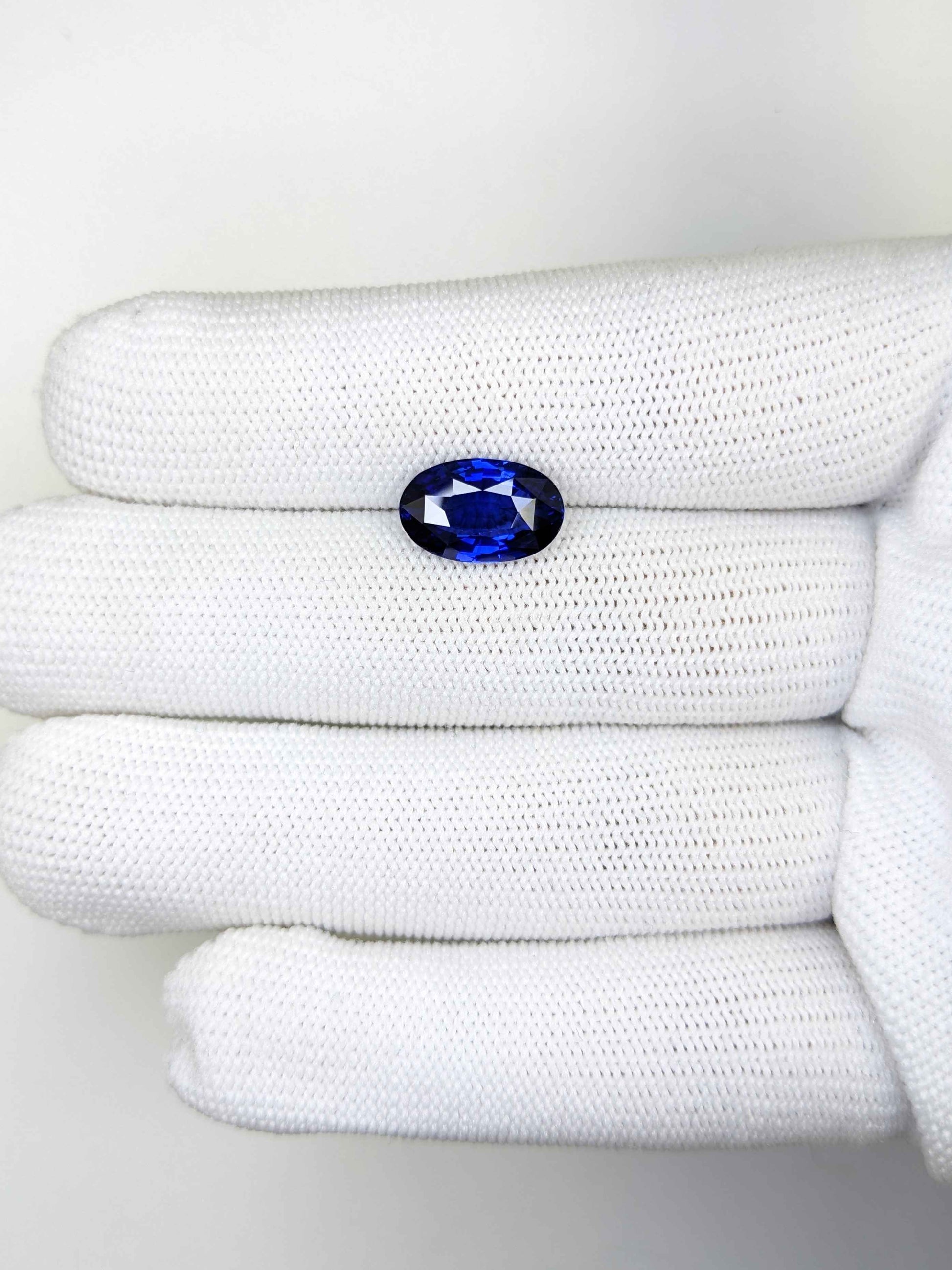 3.94 Carat Oval Cut Heat Blue Sapphire Loose Gemstone on hand