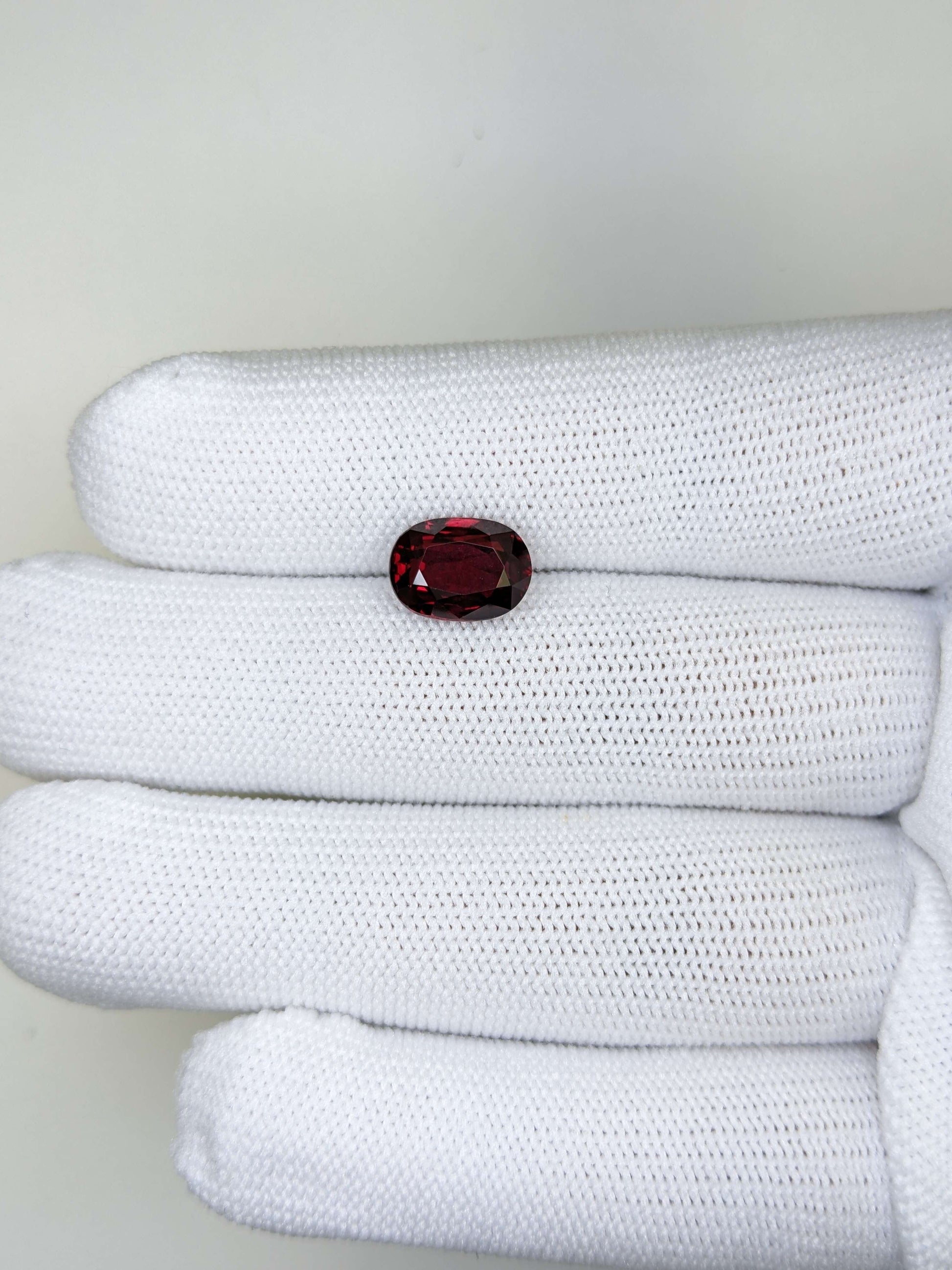 White fabric with a red ruby gemstone on a white background