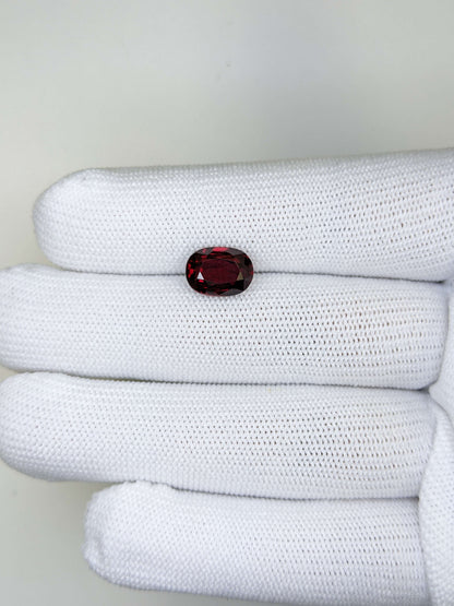 White fabric with a red ruby gemstone on a white background