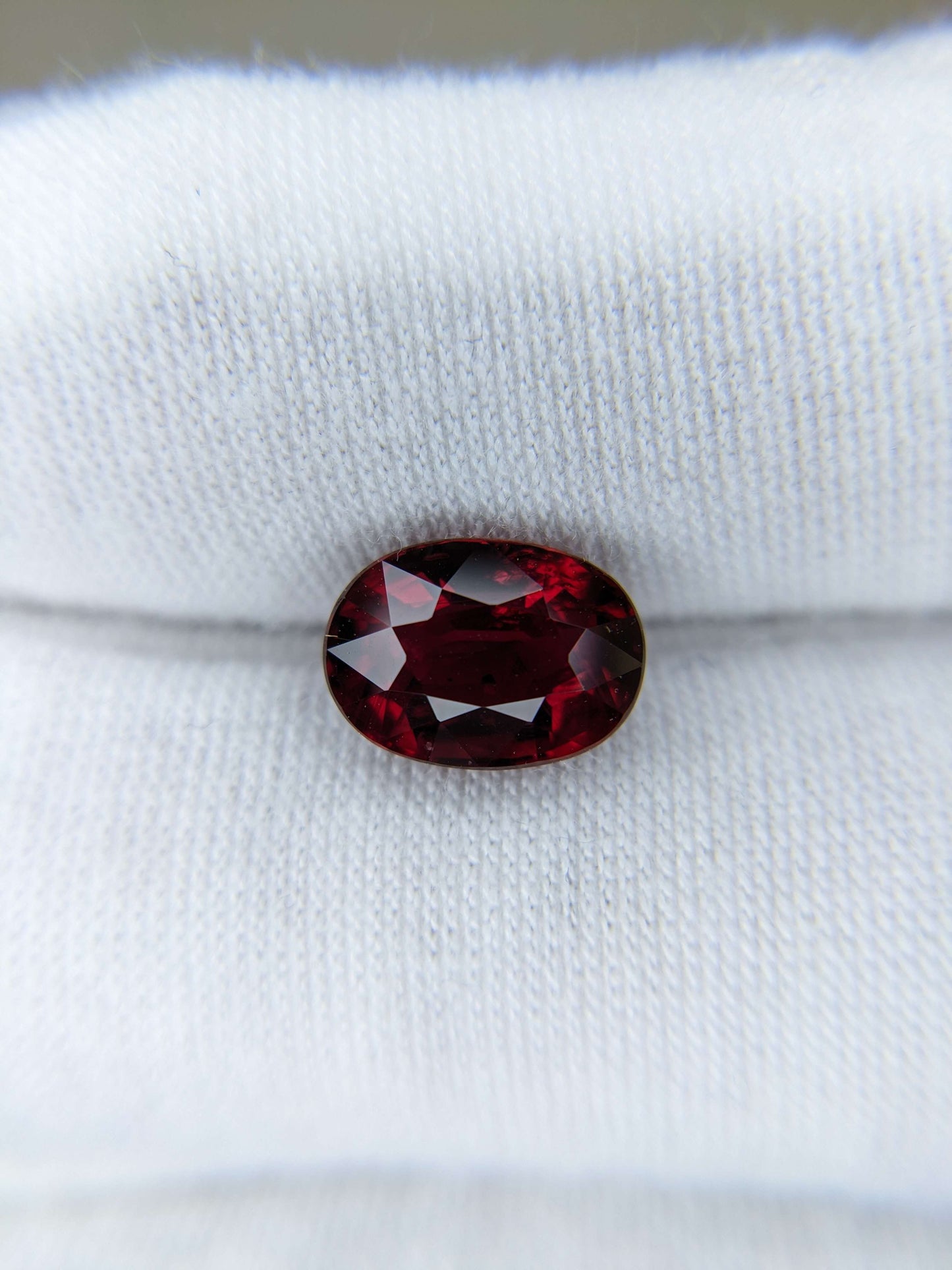 Red gemstone on a white fabric background