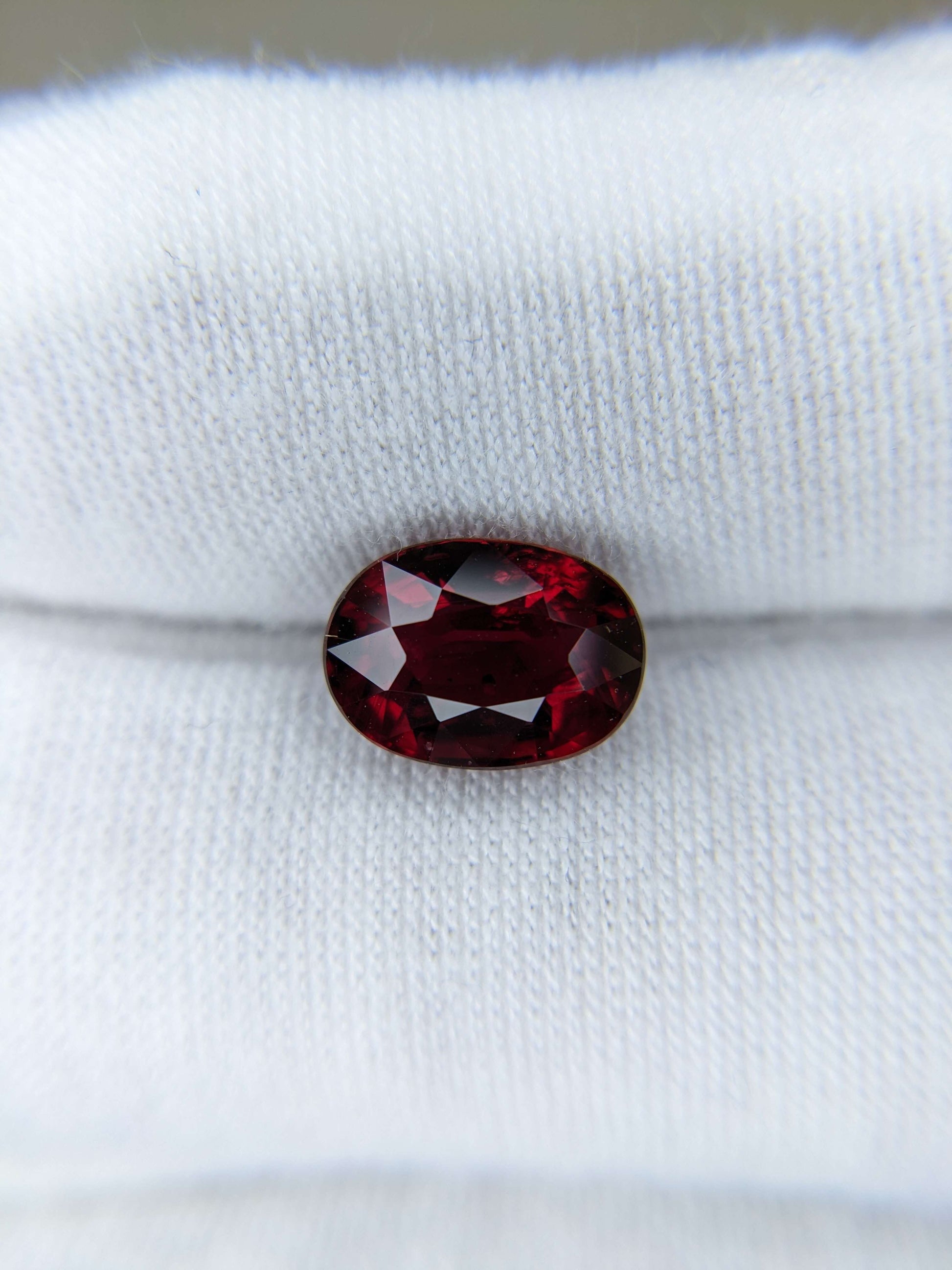 Red gemstone on a white fabric background