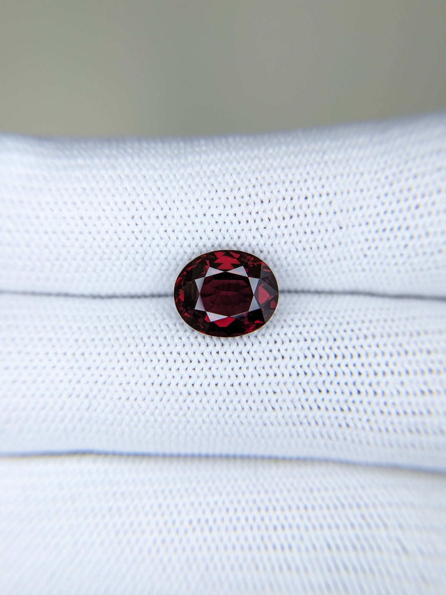 Red gemstone on a white fabric background