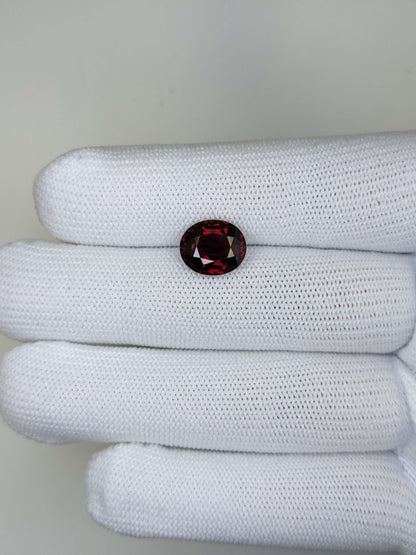 Red gemstone on a stack of white fabric