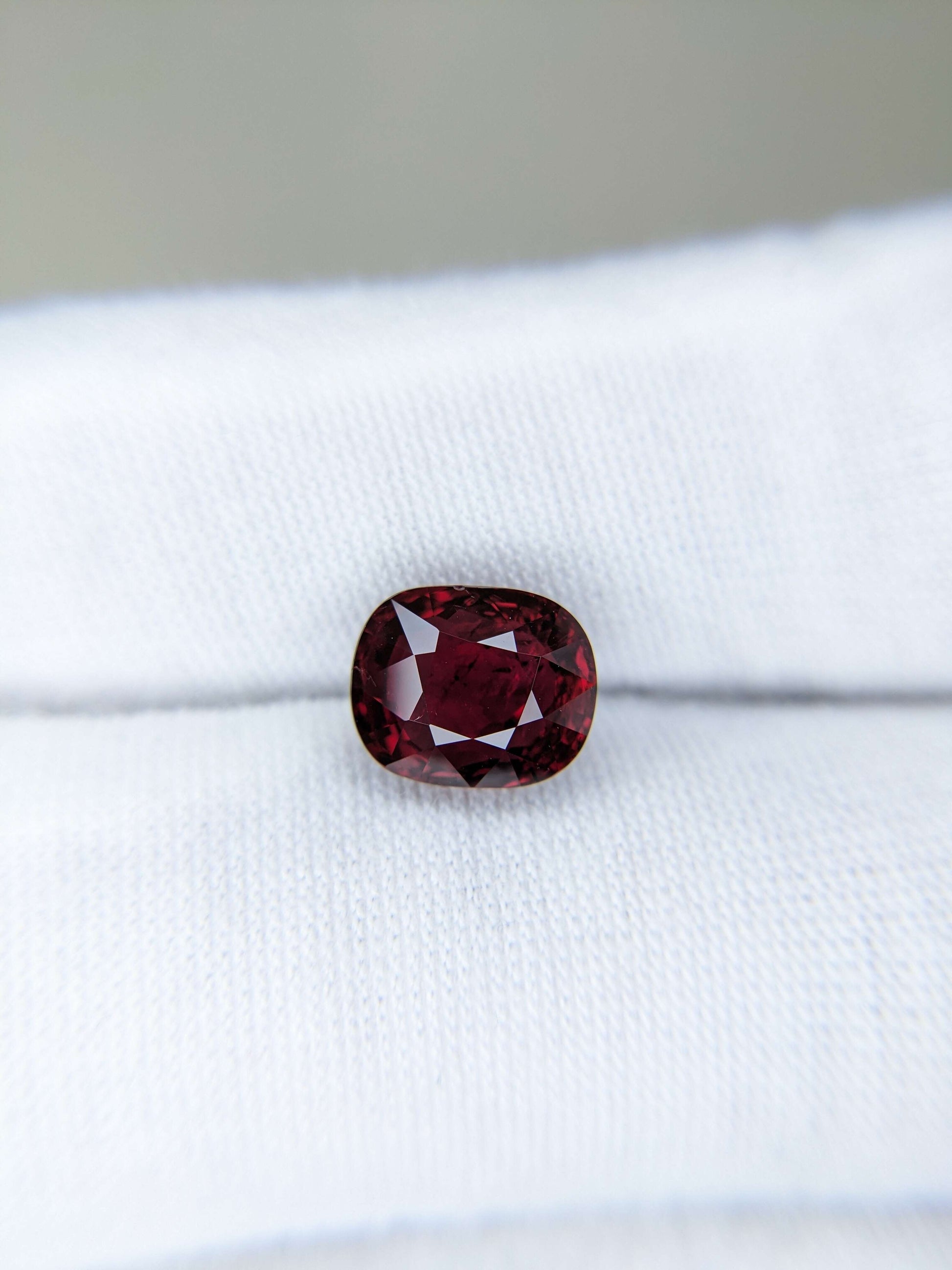 Red gemstone on a white cloth background