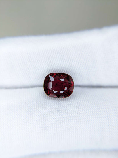 Red gemstone on a white cloth background