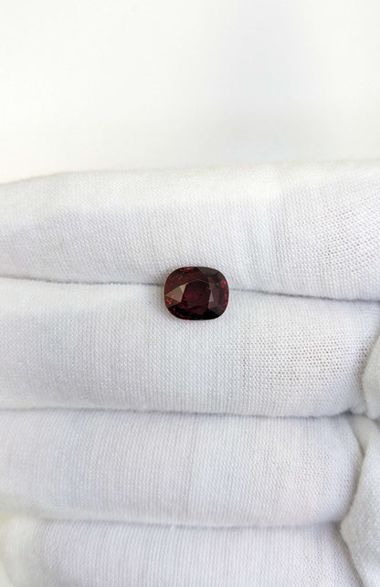 Red ruby gemstone on a white cloth background