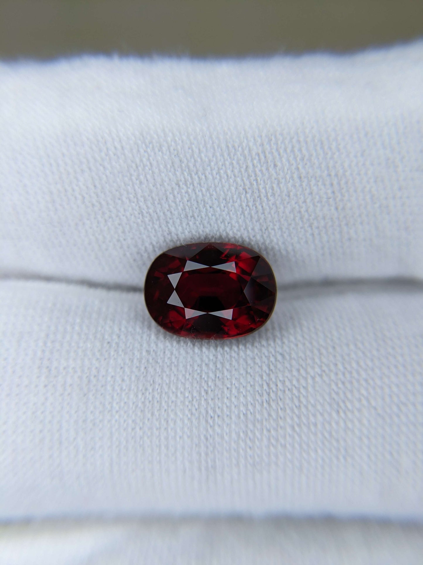Red ruby gemstone on a white cloth background