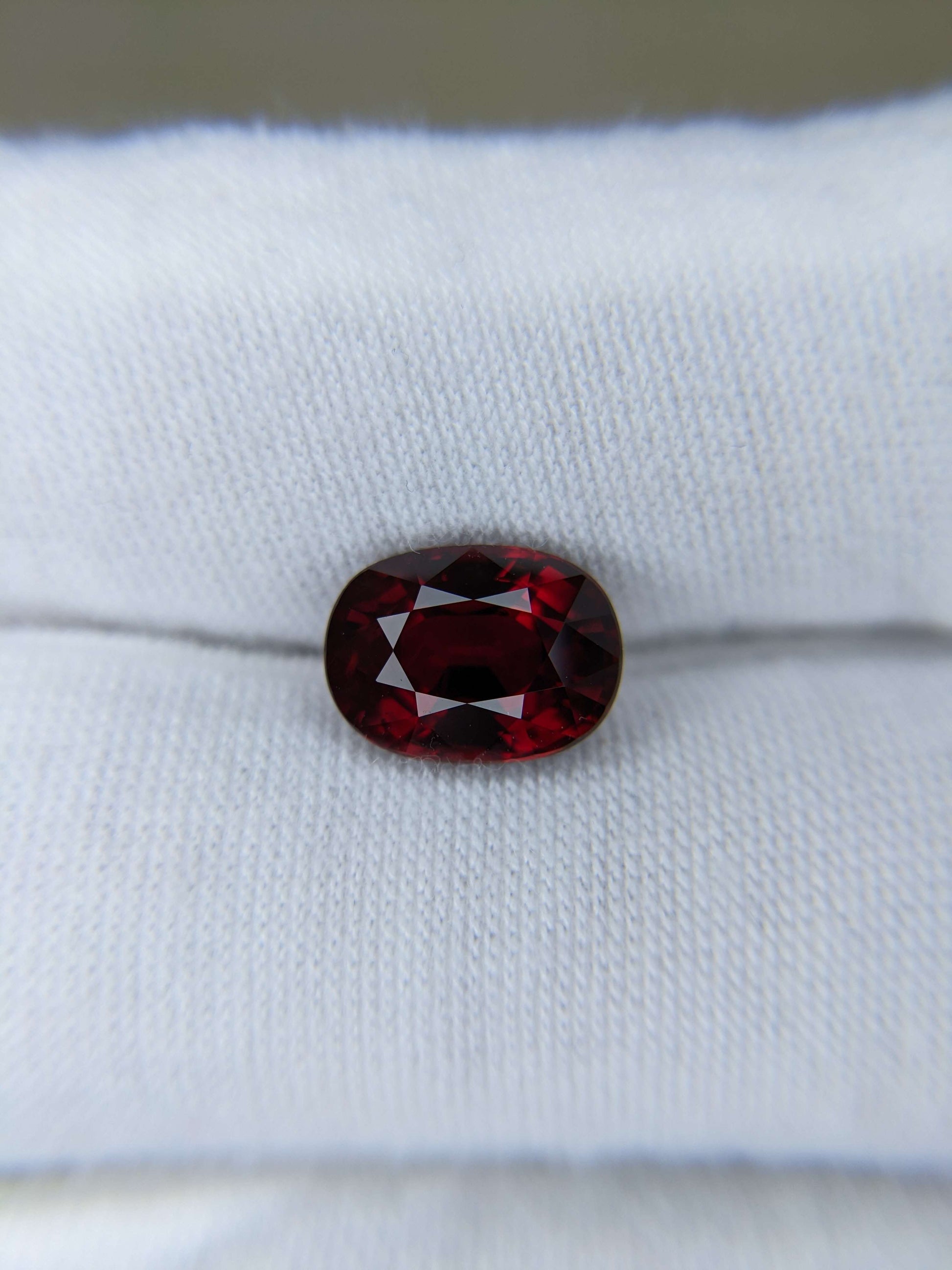 Red ruby gemstone on a white cloth background
