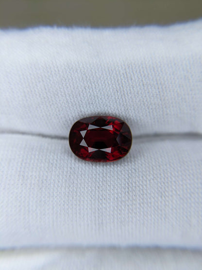 Red ruby gemstone on a white cloth background