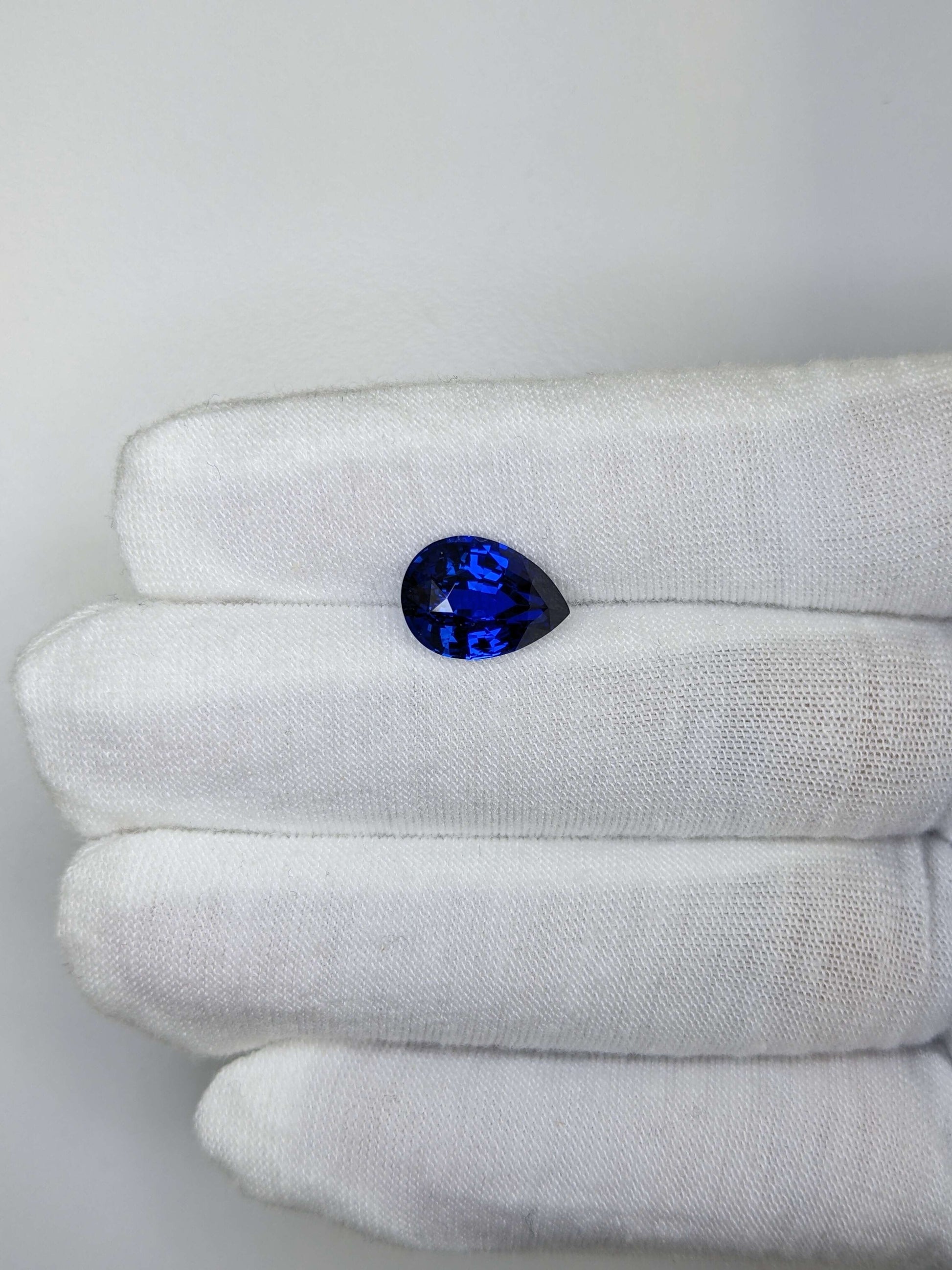 5.21 Carat Pear Cut Heat Royal Blue Sapphire Loose Gemstone On Hand