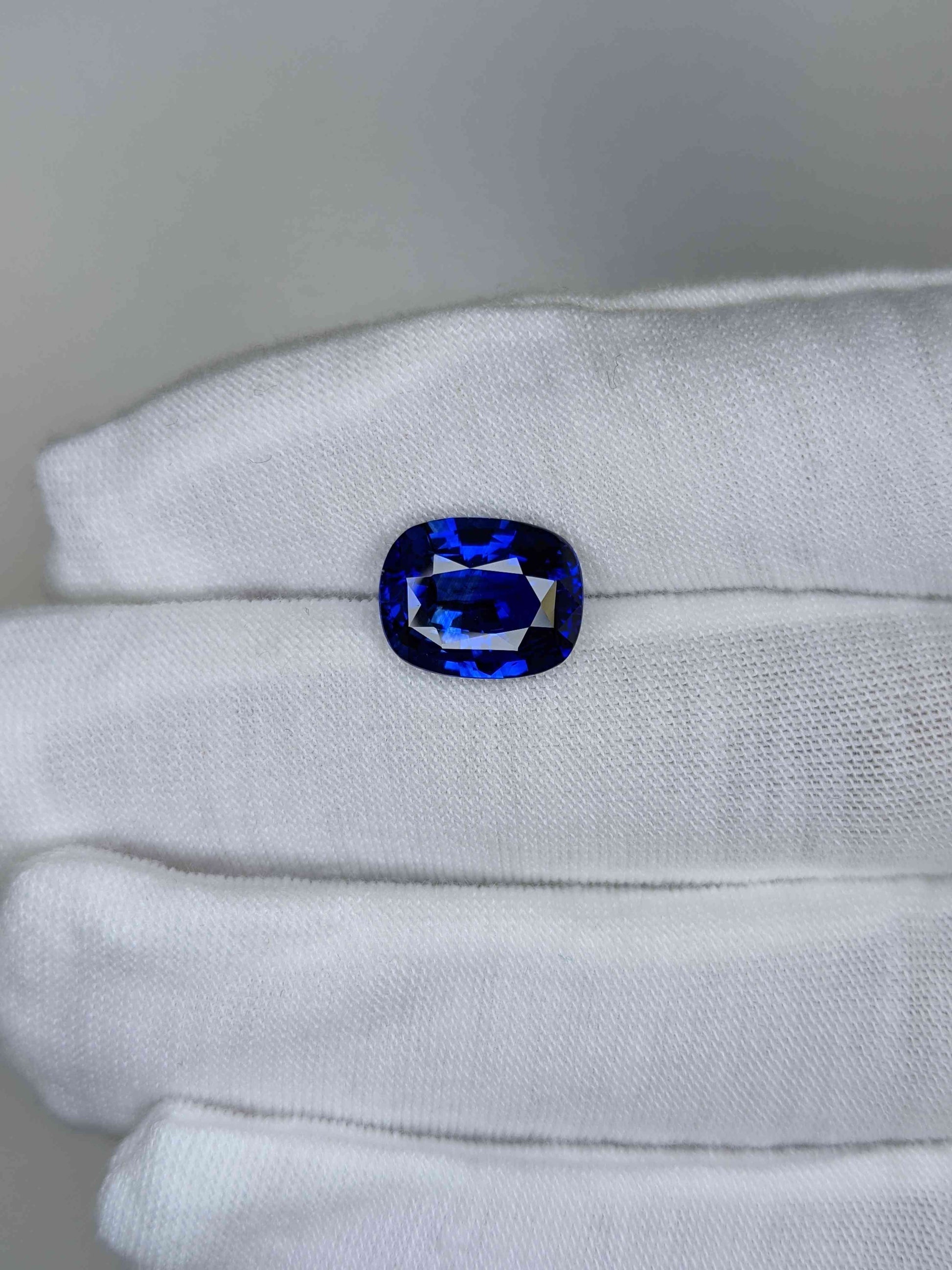 5.6 Carat Cushion Cut Heat Blue Sapphire Loose Gemstone On Hand