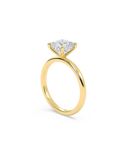 Gold ring with a cushion-shaped diamond on a white background