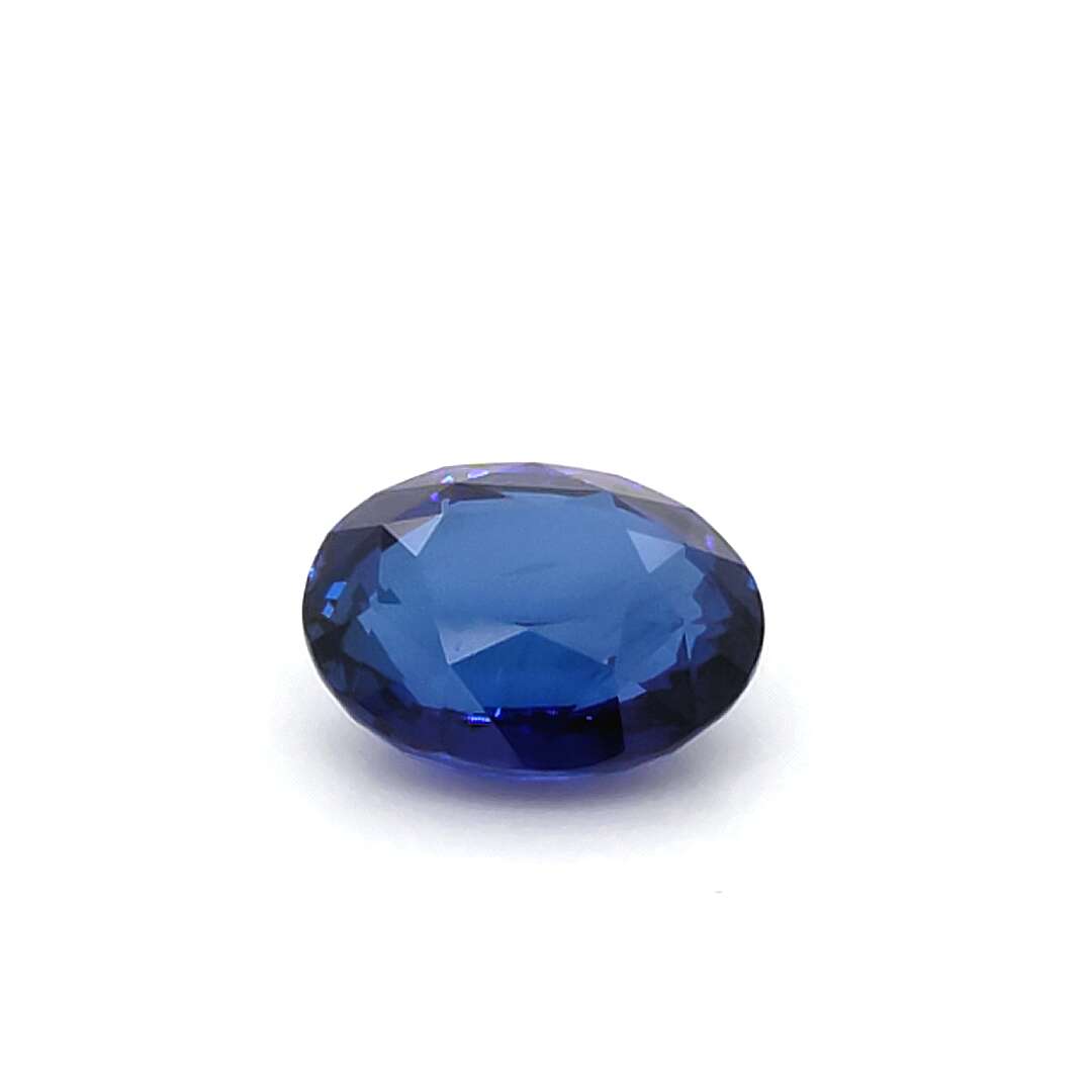 Faceted blue gemstone on a white background