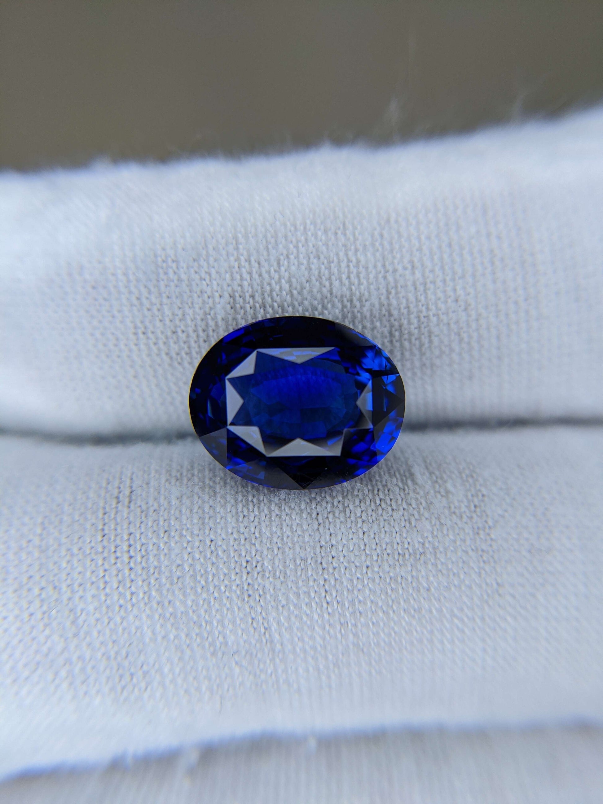 Blue gemstone on a white cloth background