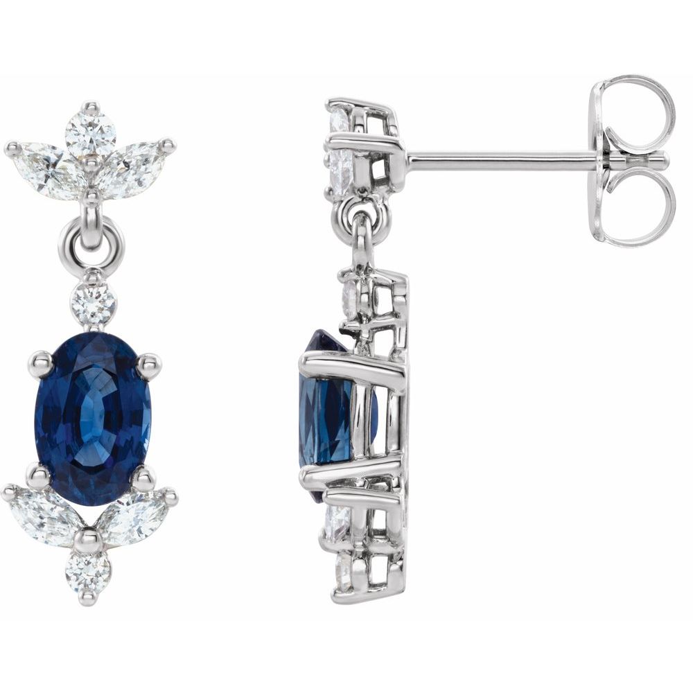 Pair of earrings with blue gemstones and diamond accents on a white background
