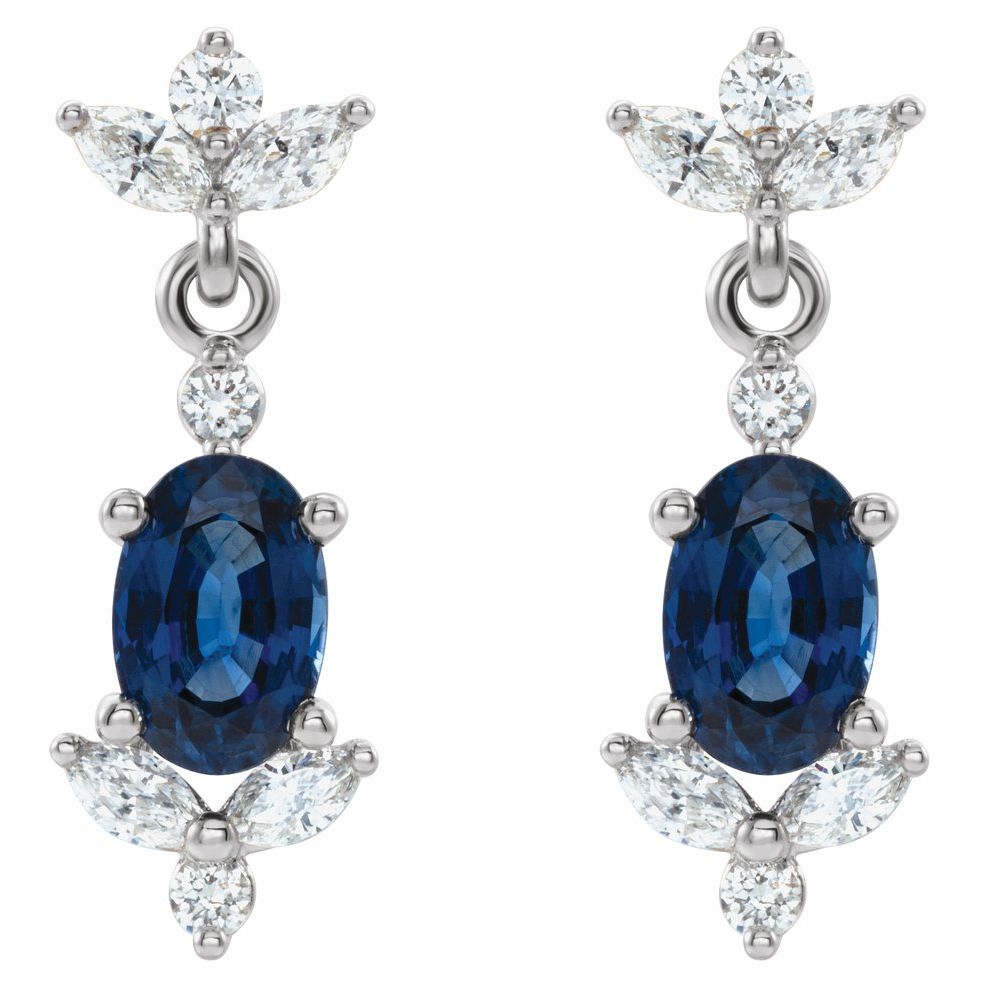 Pair of earrings with blue gemstones and diamond-like stones on a white background