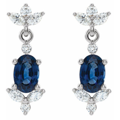 Pair of earrings with blue gemstones and diamond-like stones on a white background