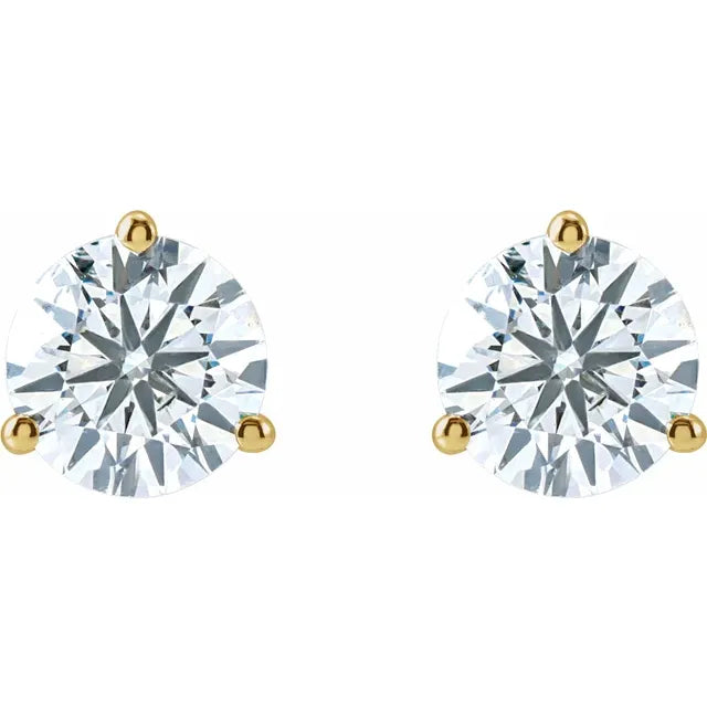 Pair of diamond stud earrings with gold prongs on a white background