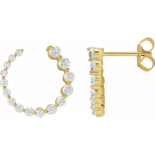 Gold earrings with clear diamonds on a white background
