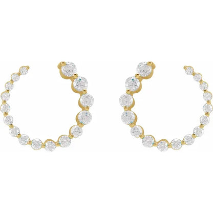 Gold stud earrings with clear gemstones on a white background