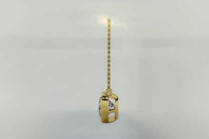 Gold pendant with a chain on a light gray background
