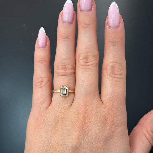 Dove 1.10 Carat Emerald Cut Diamond Solitaire Engagement Ring in 14k Yellow Gold On Hand