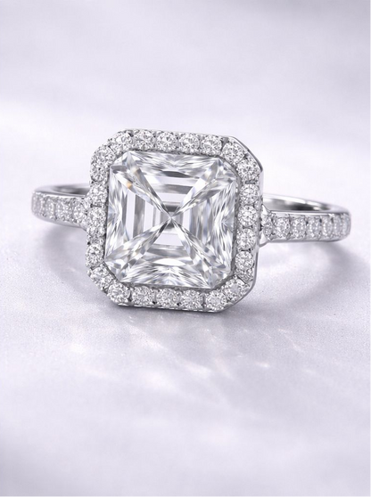 Diamond ring with a large central gemstone and smaller stones around on a light gray background for Women