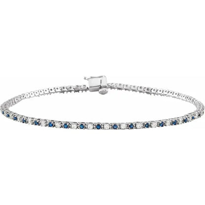 white gold tennis bracelet with blue sapphire and diamond stones on a white background