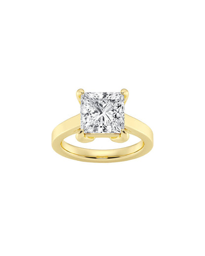 Gold ring with a large princess cut diamond on a white background