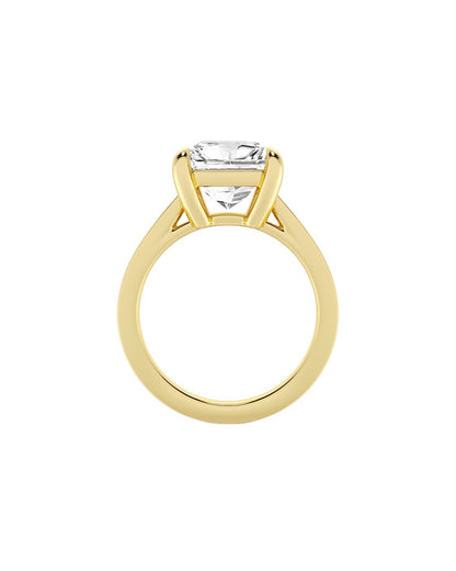 Gold ring with a clear princess cut diamond on a white background