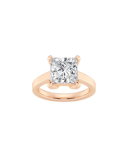 Rose gold ring with a princess cut diamond on a white background