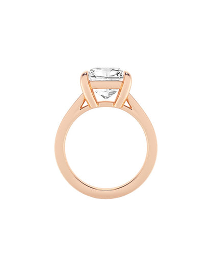 Rose gold ring with a clear diamond on a white background
