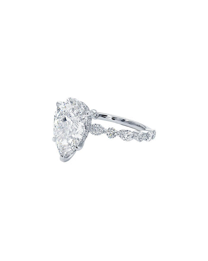 Diamond ring with a pear-shaped center stone on a white background