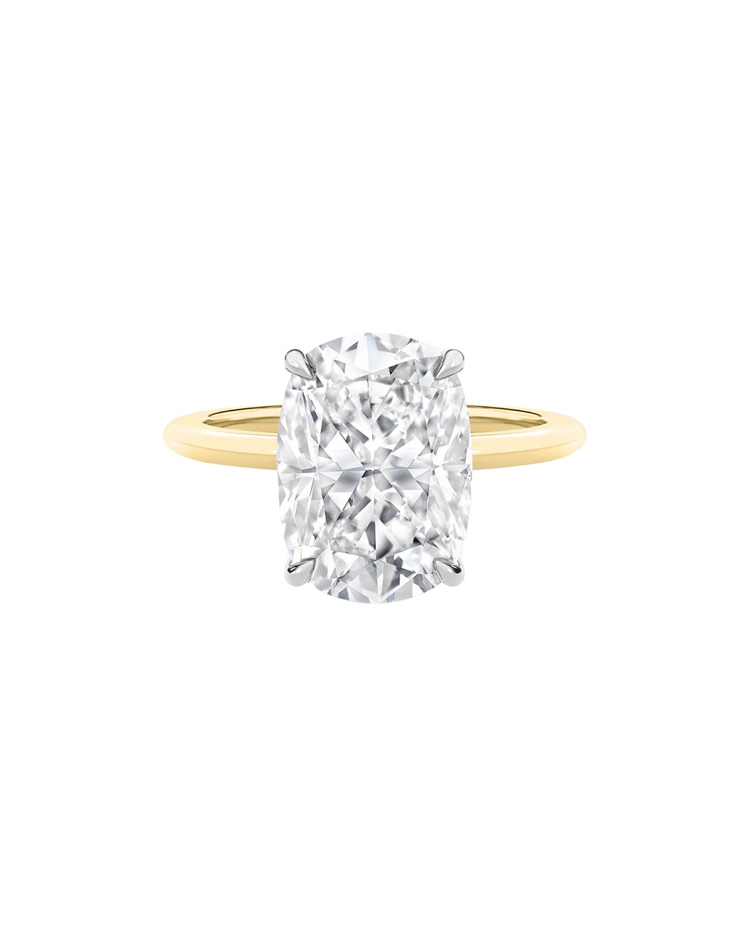 Yellow gold ring with a large cushion cut diamond on a white background