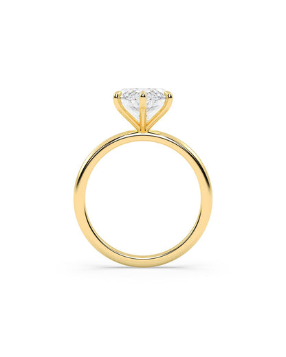 Gold ring with a clear gemstone on a white background