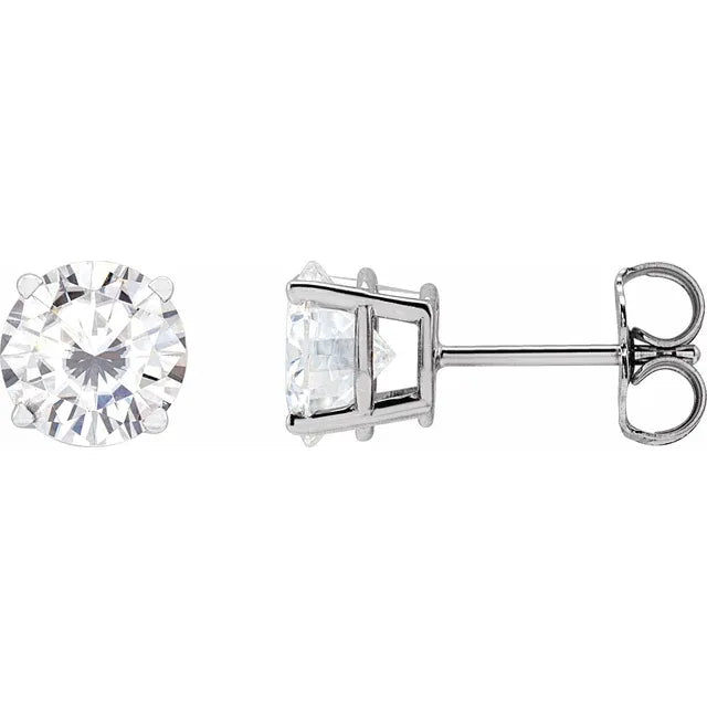Two diamond earrings on a white background