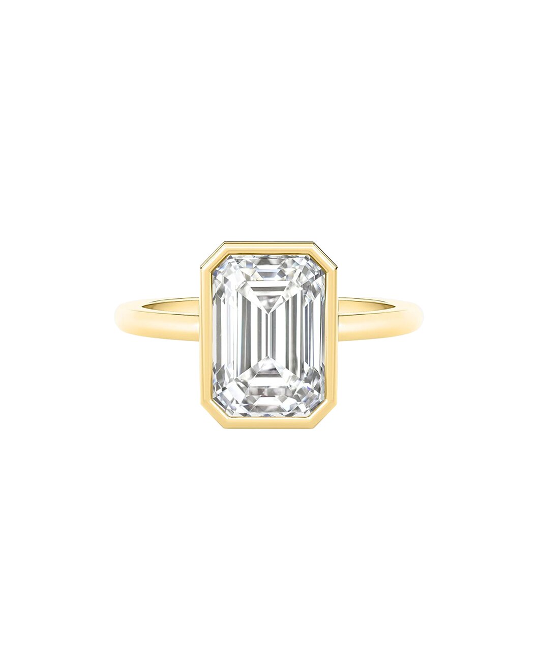 Gold ring with an emerald cut diamond on a white background