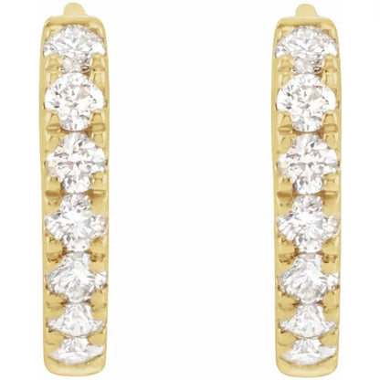 Gold hoop earrings with clear gemstones on a white background