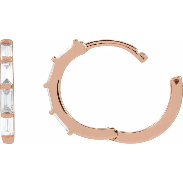 Rose gold hoop earrings with clear diamonds on a white background