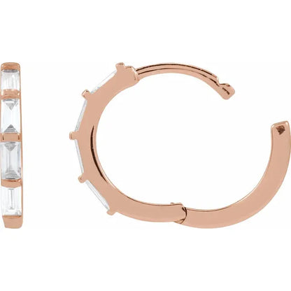 Rose gold hoop earrings with clear diamonds on a white background