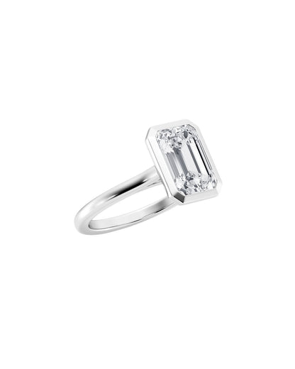 Diamond ring with emerald-cut stone on a white background