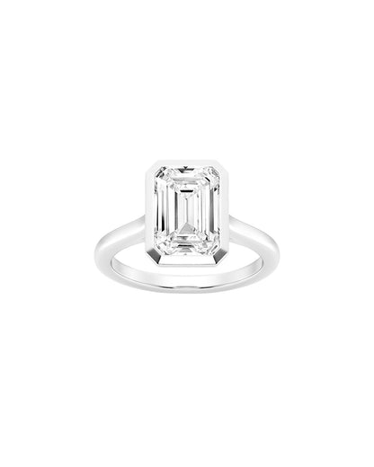 Diamond ring with emerald-cut gemstone on a white background