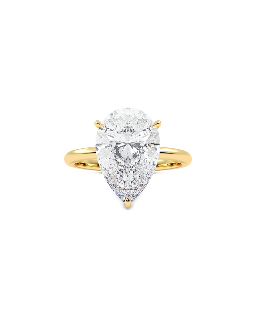 Gold ring with a pear-shaped diamond on a white background