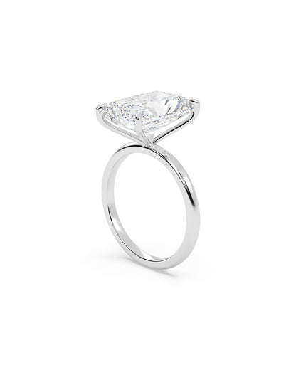 Diamond ring with a radiant cut stone on a white background