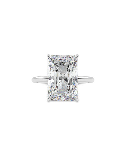 Diamond ring with a radiant cut gemstone on a white background