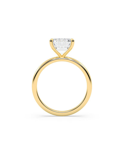 Gold ring with a clear diamond on a white background