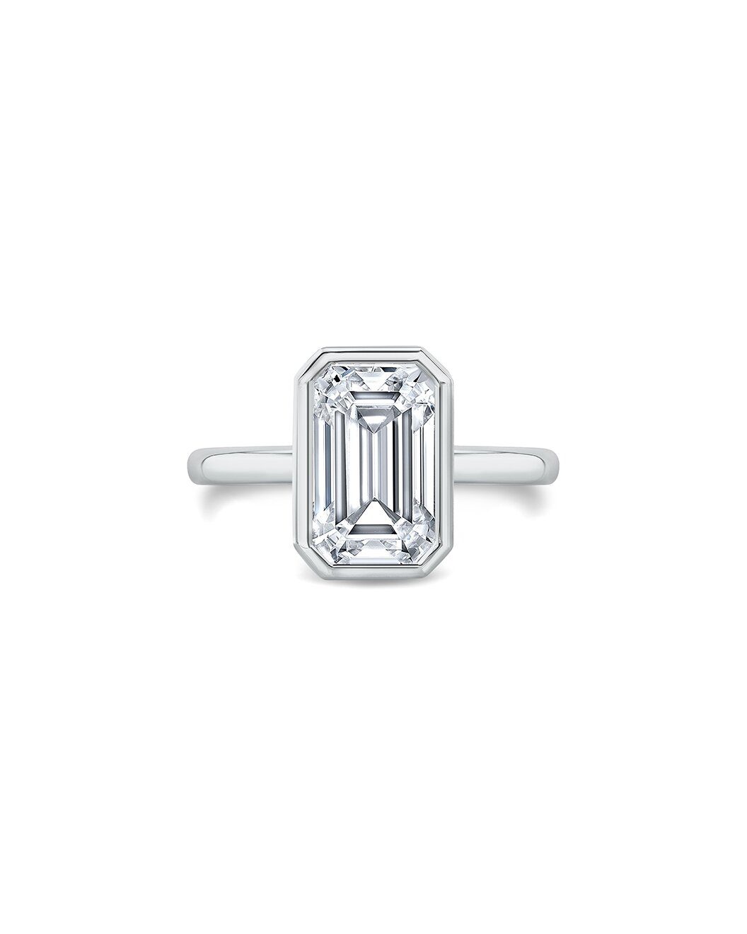 Diamond ring with emerald-cut gemstone on a white background