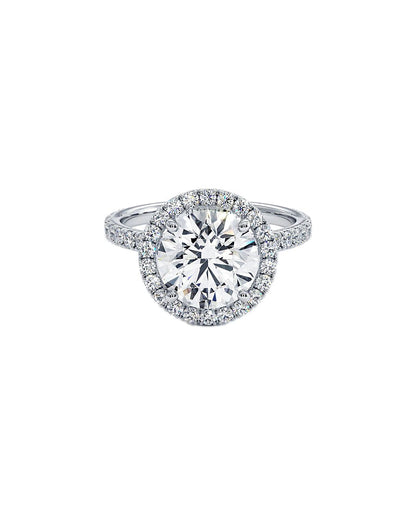 Diamond ring with a halo on a white background