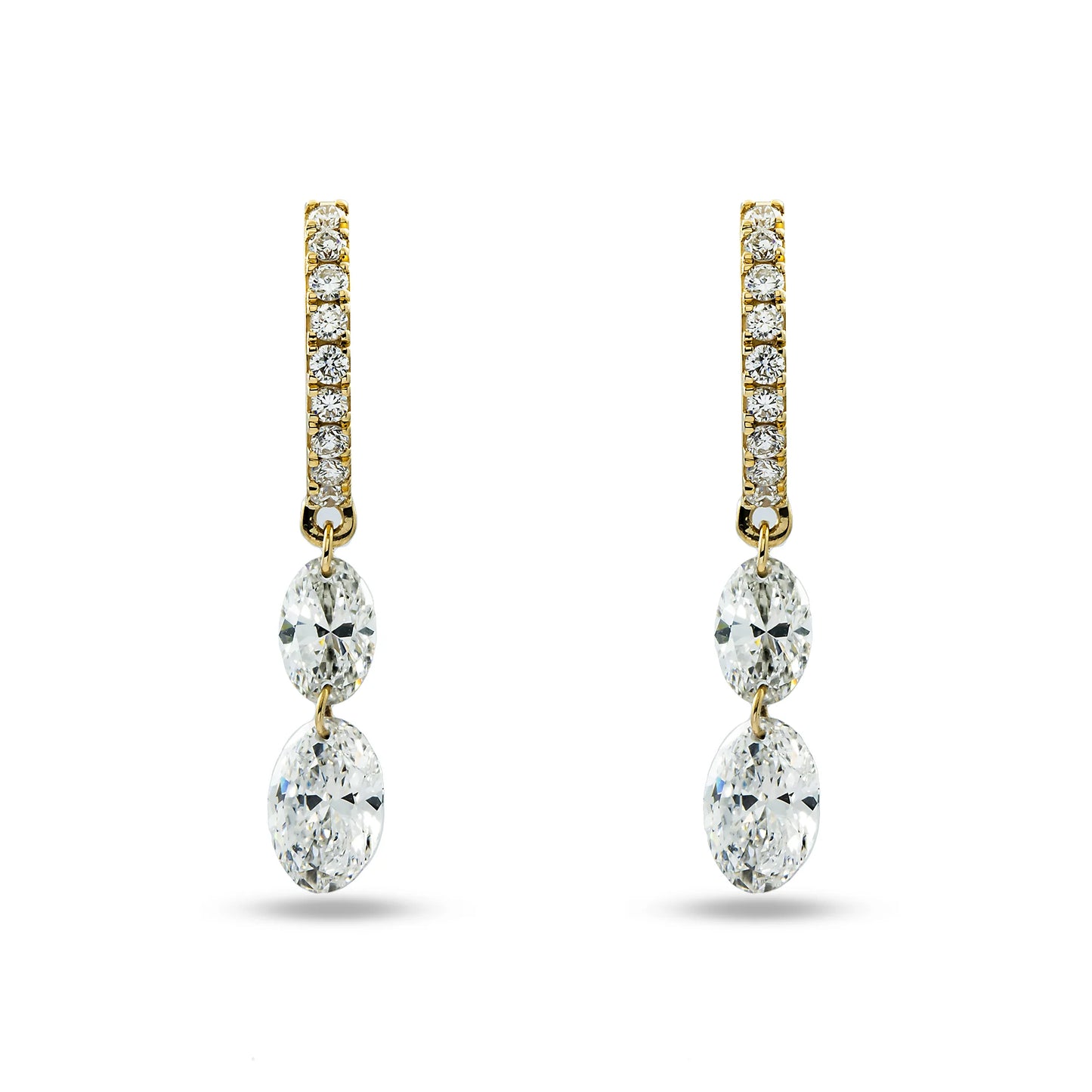 Gold and diamond earrings on a white background