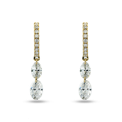 Gold and diamond earrings on a white background